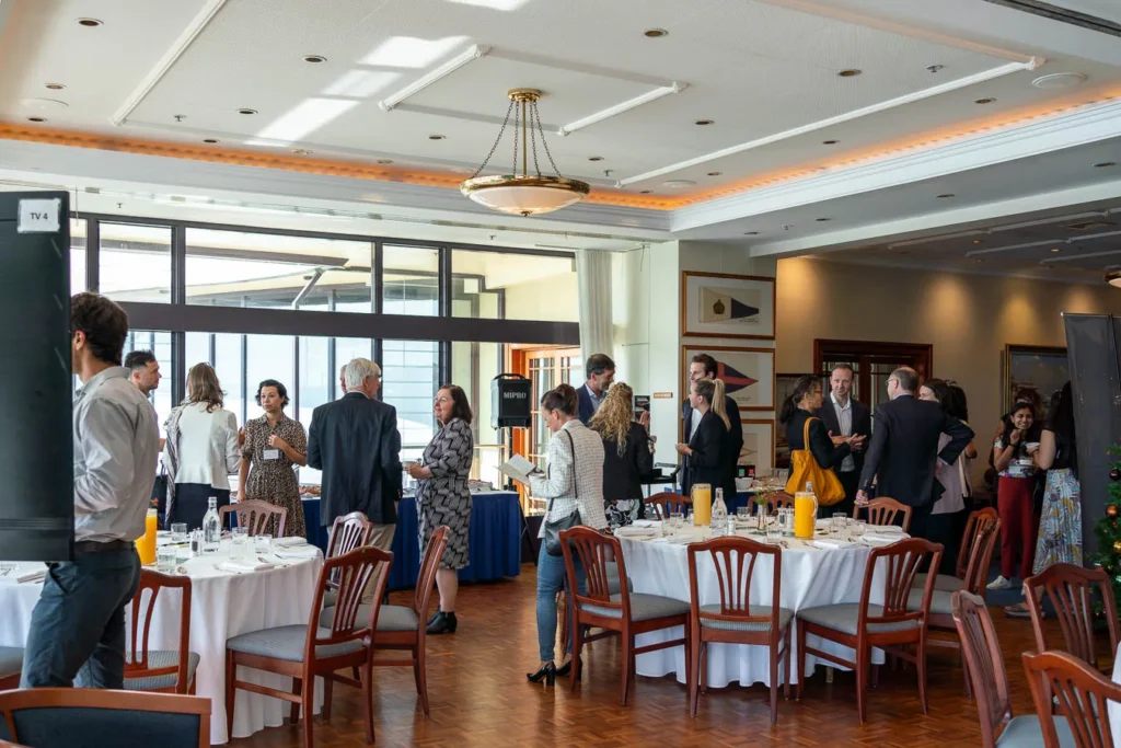 Business professional speaking with guests after session