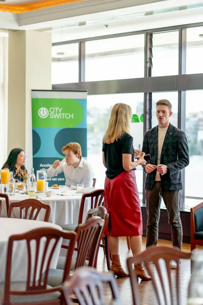 Guest enjoying a conversation over coffee at CitySwitch net zero event
