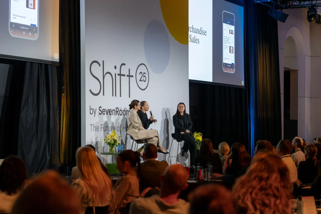 Speakers seated on stage during industry panel