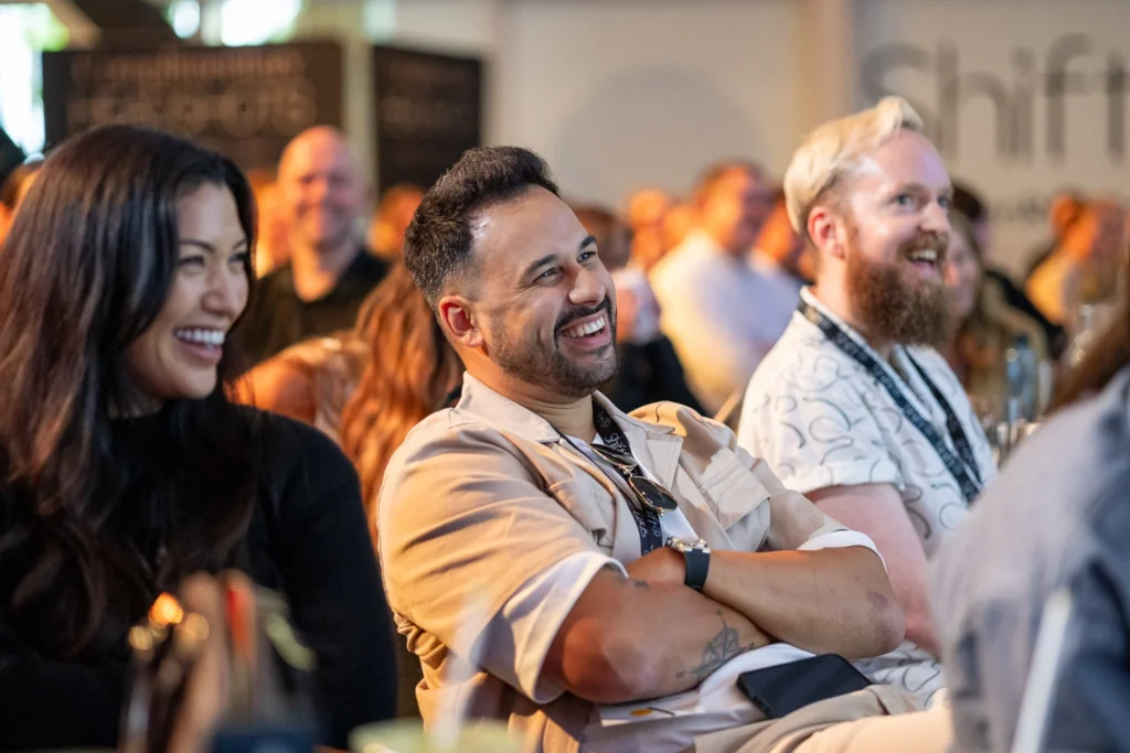 People talking and laughing at conference networking session