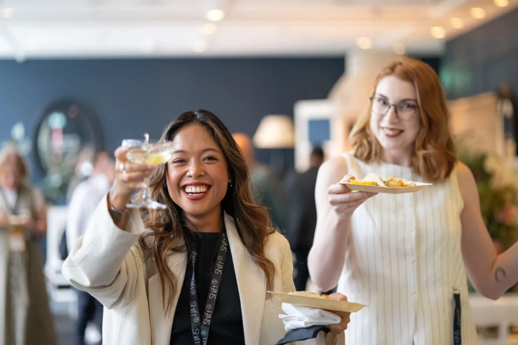 Guests holding branded cocktails at afterparty