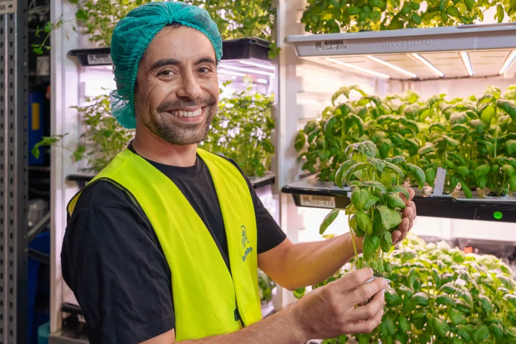 Portrait of InvertiGro staff member inside indoor vertical farm