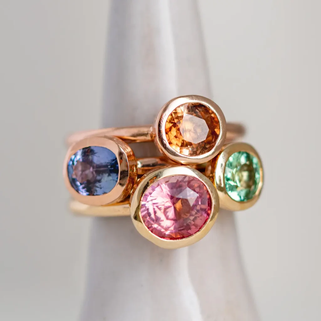 pink, green, blue and yellow gold tourmaline rings photographed in studio