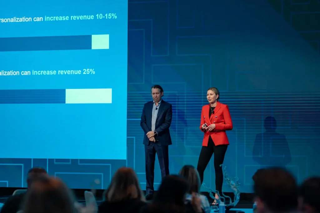 Speaker in a red blazer presenting on stage at Guidewire Insurance Forum Sydney 2023