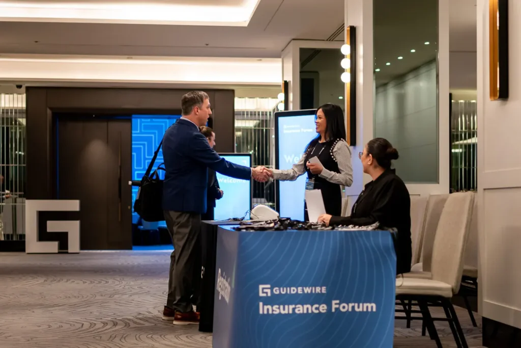 Guests arriving at the registration desk for Guidewire Insurance Forum Sydney 2023 at Four Seasons Hotel Sydney