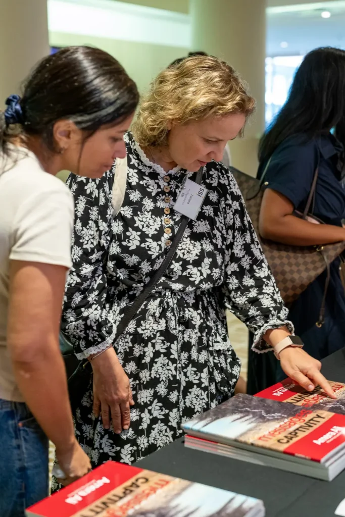 Guests viewing copies of Messages from Captivity at the book launch event