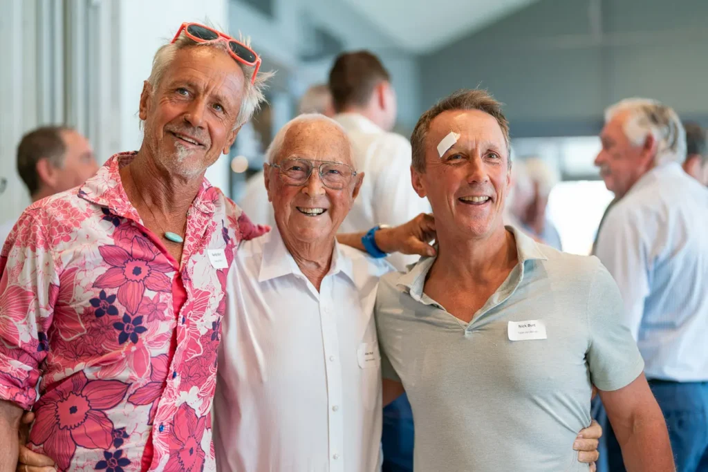 Three guests smiling together at the Michael Morgan OAM lunch at Deckhouse Woolwich