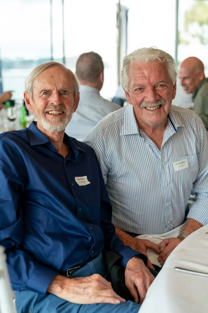Two guests smiling for a portrait at the Michael Morgan OAM lunch