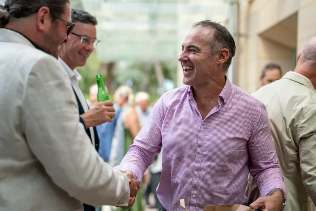 Former rowing colleagues reconnecting and laughing at the Michael Morgan OAM lunch
