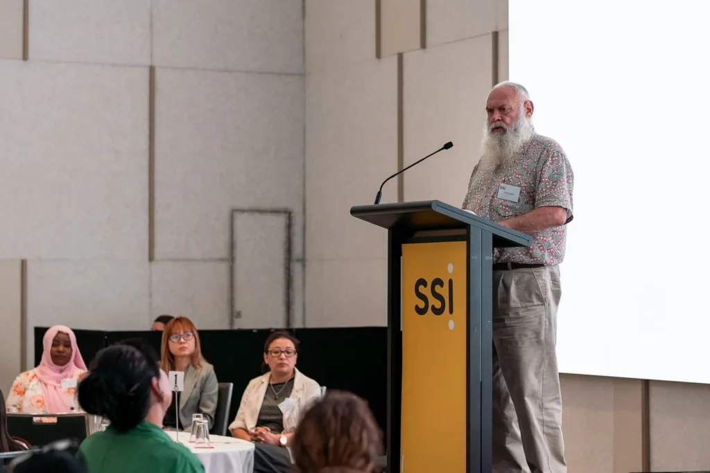 Speaker at the SSI podium addressing guests during the conference in Parramatta