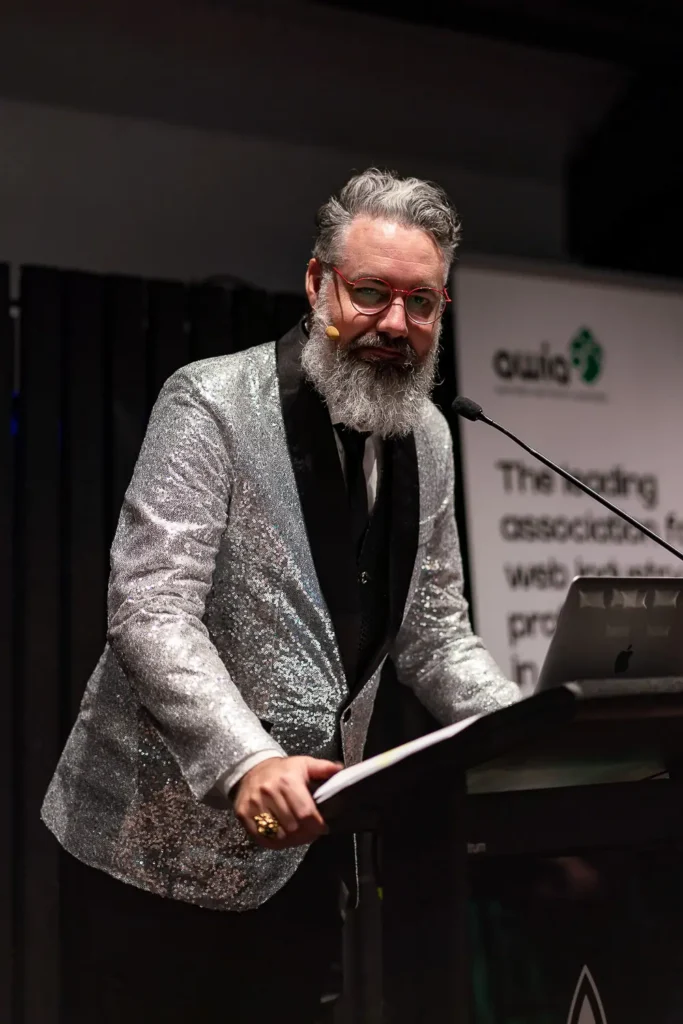 Speaker presenting on stage at Australian Web Awards