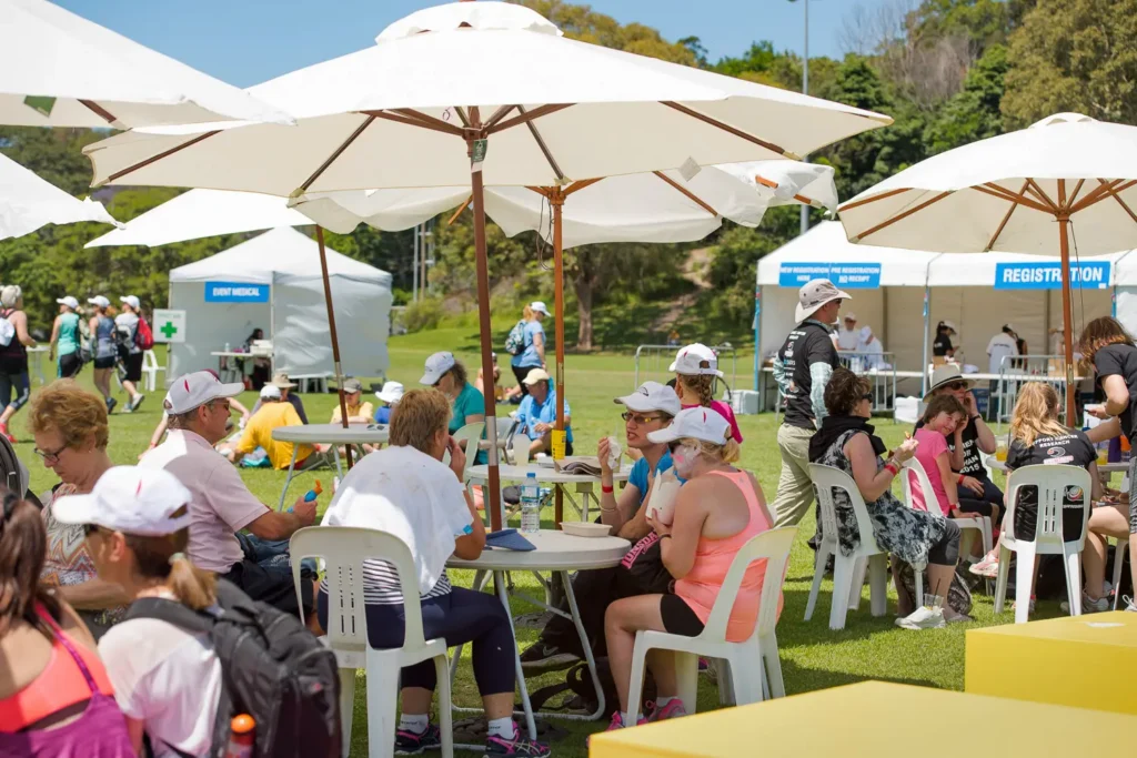 Participants relaxing in the shaded rest area during the Bridges Walk charity event in Sydney