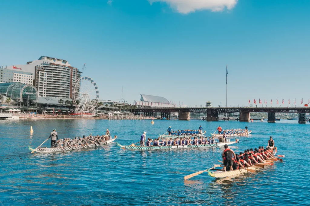 Multiple dragon boat teams competing during races at Darling Harbour Sydney