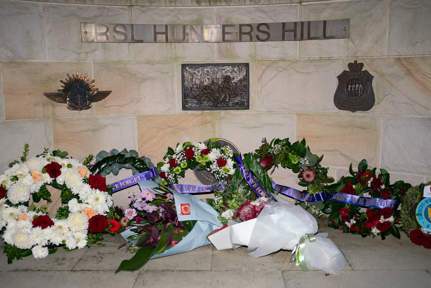 Wreaths and floral tributes at the Hunters Hill RSL Memorial Wall