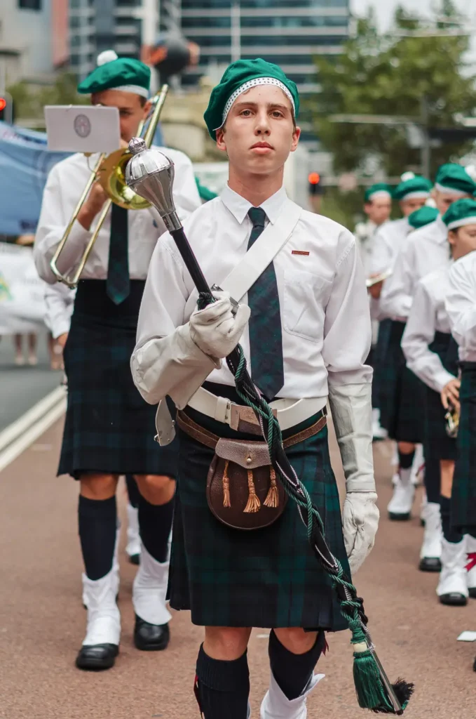 Young pipe band leader marching in traditional Irish uniform at Sydney parade