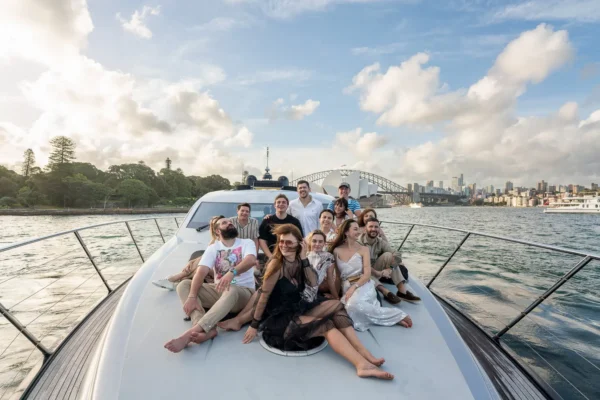 Guests relaxing together on a luxury yacht during a sunset cruise in Sydney Harbour