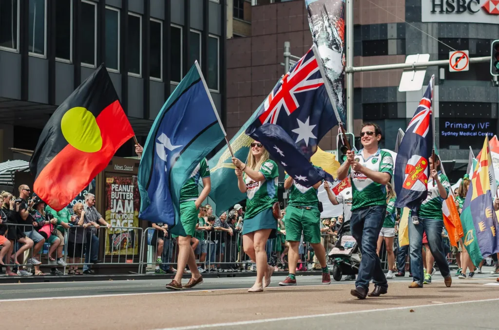 Parade participants carrying cultural flags during Sydney St Patrick’s Day celebrations