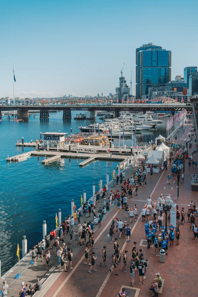 Teams and spectators gathering beside the harbour during dragon boat races in Sydney