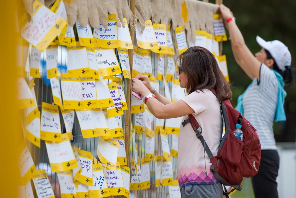 Participants placing messages on the Village of Hope wall during the charity walk