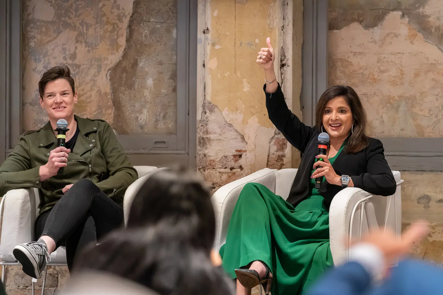 Yamini Rangan and Sarah McDevitt speaking during a corporate conference panel discussion