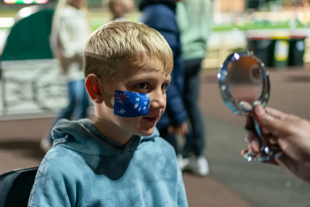 Child with Australian flag face paint at the Matildas community event