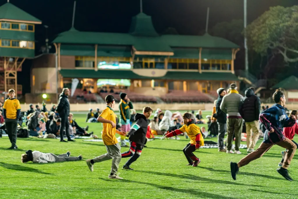 Children playing on the grass during the Matildas live site at North Sydney Oval
