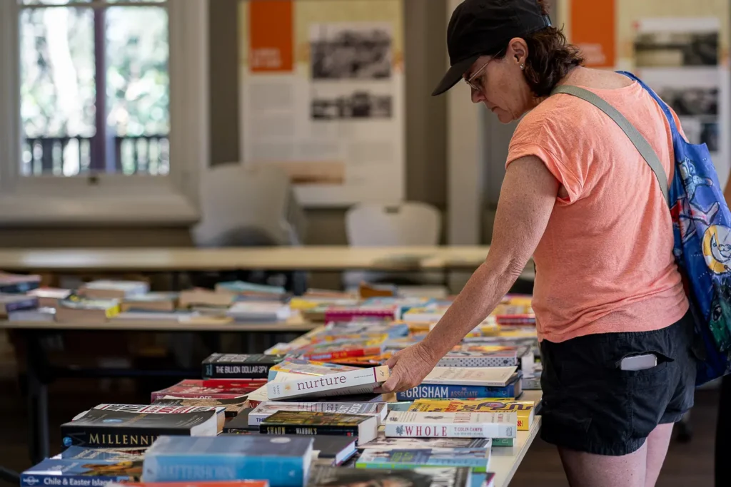 Visitor browsing second-hand books at the Coal Loader Sustainability Festival