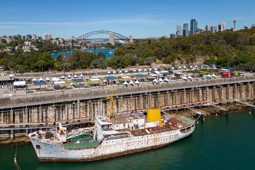Aerial view of the Coal Loader Sustainability Festival in Waverton with Sydney Harbour Bridge in the background