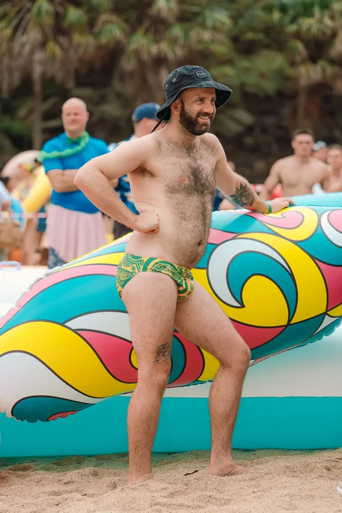 Participant posing beside a colourful inflatable before the Manly Inflatable Boat Race