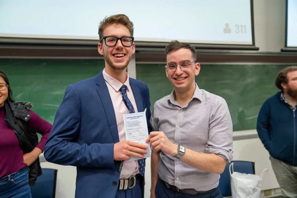 Two smiling conference attendees posing together after a session