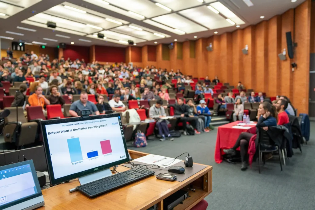 Large conference audience participating in a live poll inside a lecture theatre