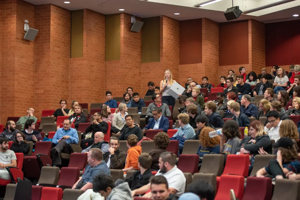 Students taking part in a discussion inside Eastern Avenue Auditorium