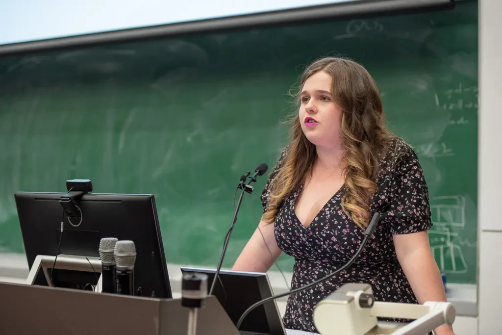 Female speaker presenting at the Socialism vs Capitalism debate at the University of Sydne