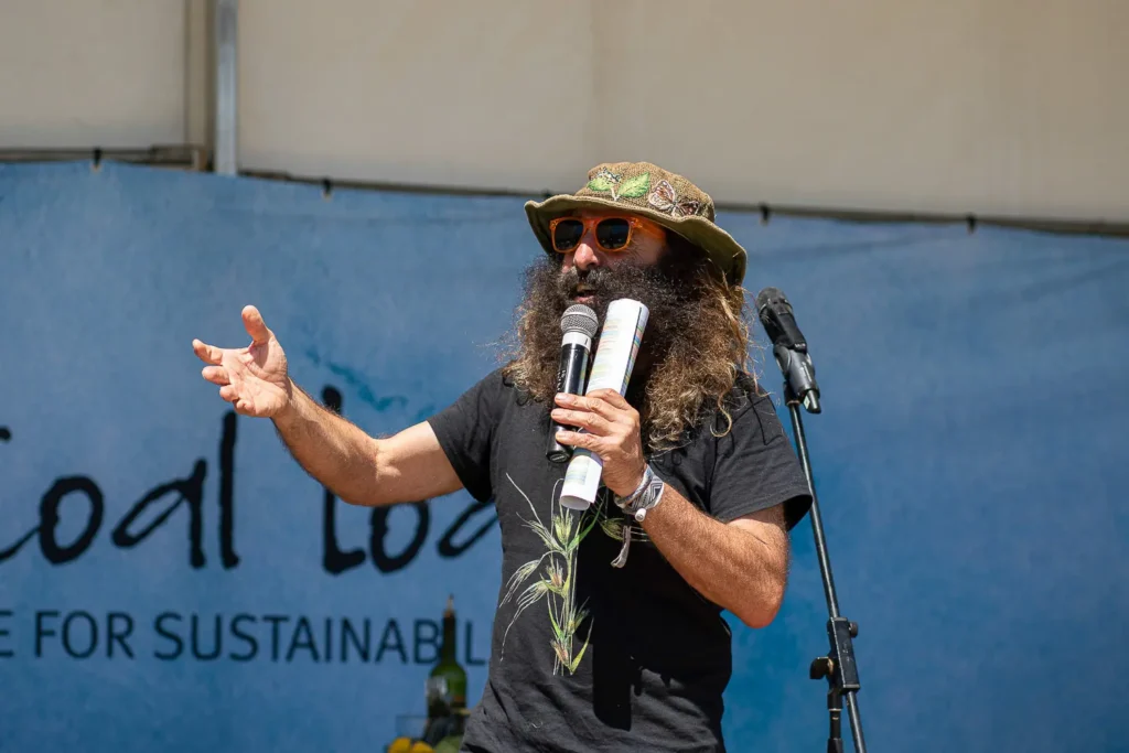 Guest speaker addressing visitors on stage at the Coal Loader Sustainability Festival