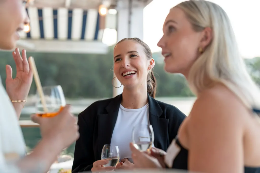 Guests laughing and socialising over drinks at the Shift networking event