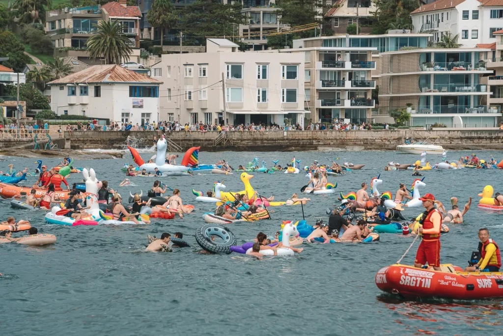 Surf Rescue crew patrolling a busy field of inflatable racers at Manly