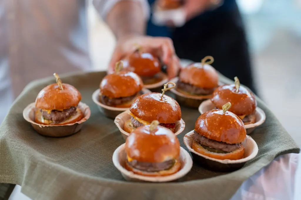 Tray of mini burgers served as canapés at a corporate event