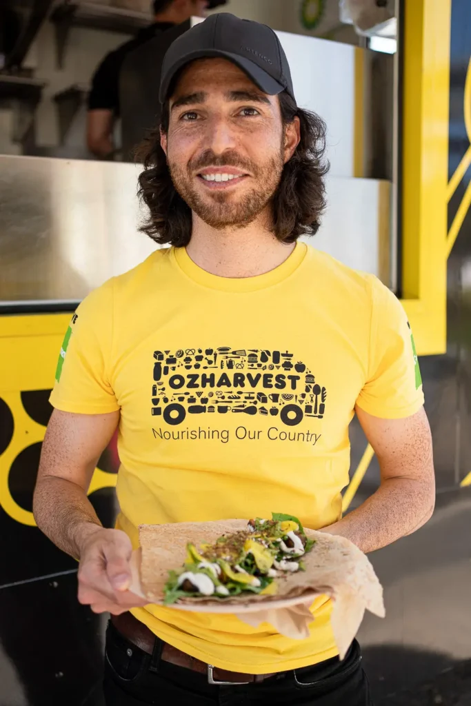 OzHarvest team member serving sustainable food at an outdoor community event