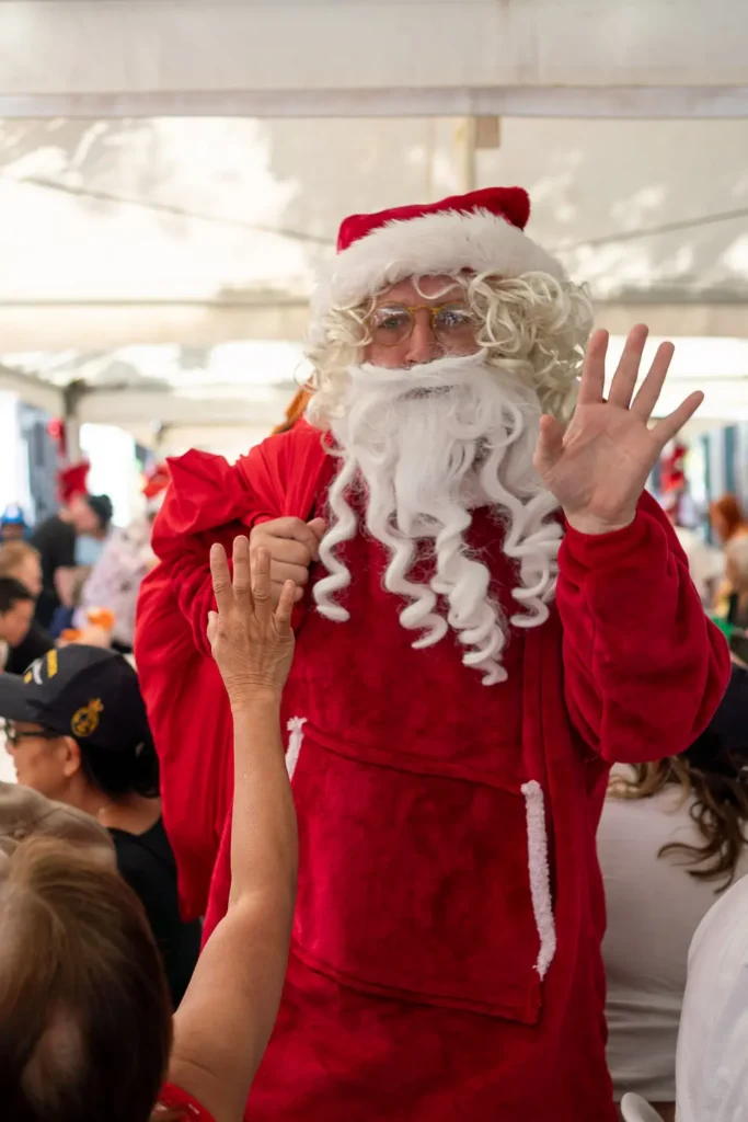 Santa greeting guests at the Wayside Chapel Christmas Day celebration