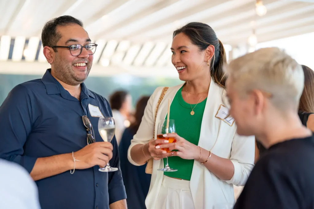 Guests smiling and networking over drinks at the Shift conference event