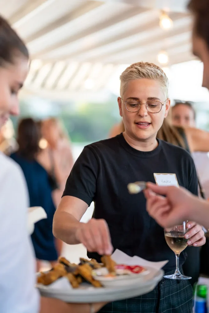 Guest enjoying canapés and wine during a relaxed networking event