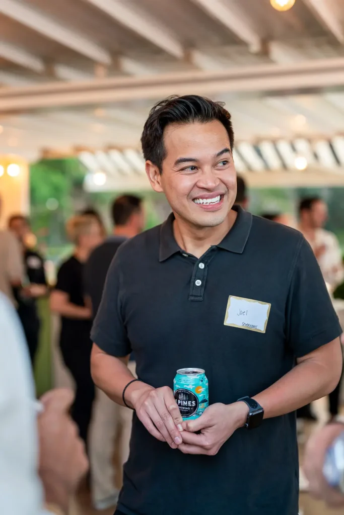 Smiling guest holding a drink during the Shift conference networking event