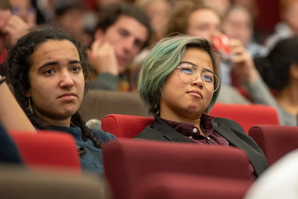 Students listening to speakers inside Eastern Avenue Auditorium at the University of Sydney