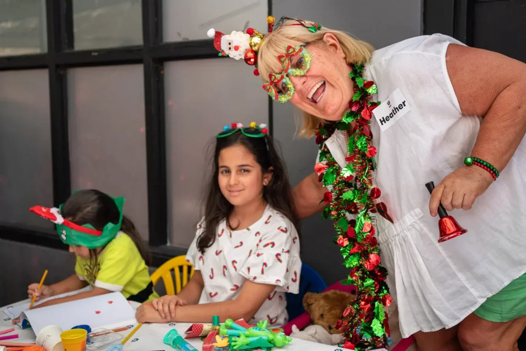 Wayside Chapel volunteer with children at the Christmas Day arts and activities area