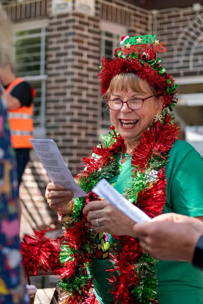 Guest dressed in Christmas tinsel enjoying the Wayside Chapel community celebration