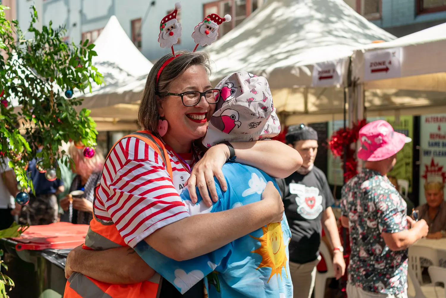 Wayside Chapel volunteer sharing a warm hug during the Christmas Day community celebration