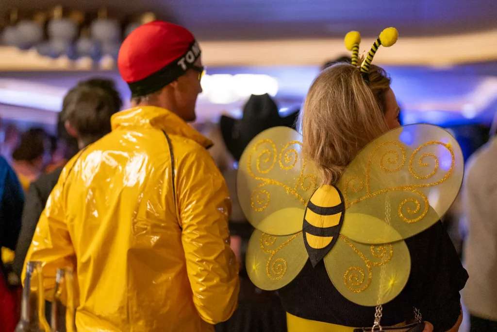 Guest wearing bee wings and antennae at a Sydney corporate costume party