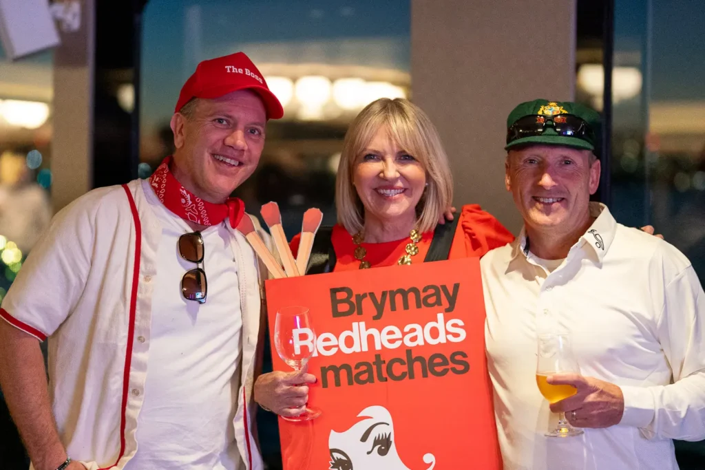 Guests posing with a Brymay Redheads matches costume at a Sydney corporate party