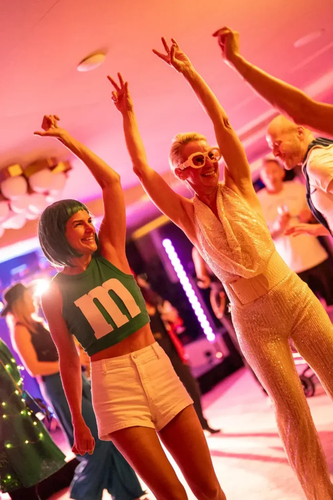 Guests dancing in colourful costumes at a corporate event in Sydney