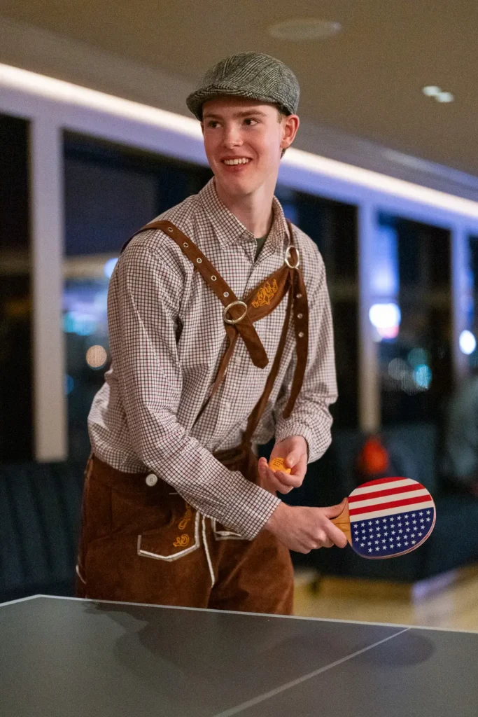 Guest in costume playing table tennis during a Sydney corporate event